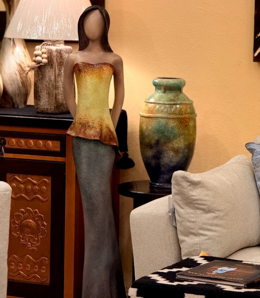 Nadia, a tall standing female form sculpted in clay by Loretta Bertoli