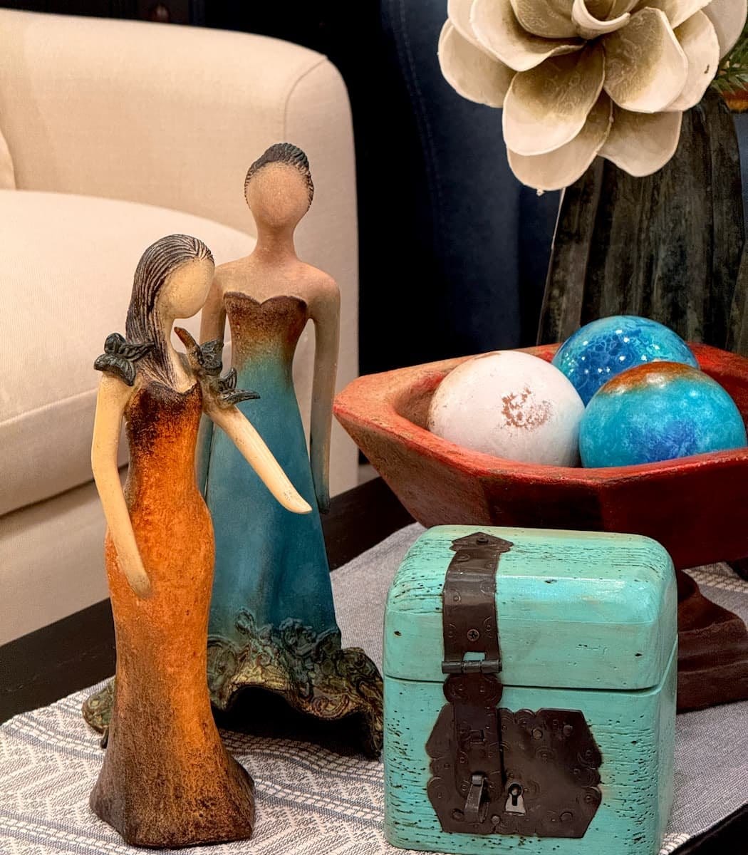 A group of small female form sculptures in clay by Loretta Bertoli