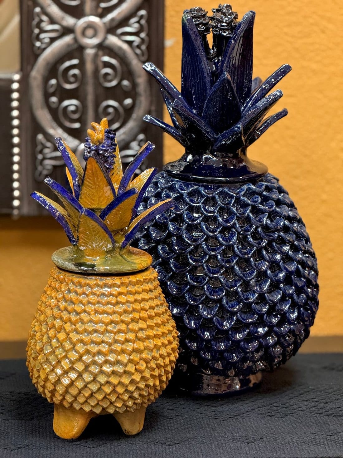 Blue and yellow decorative clay piñas from Michoacán