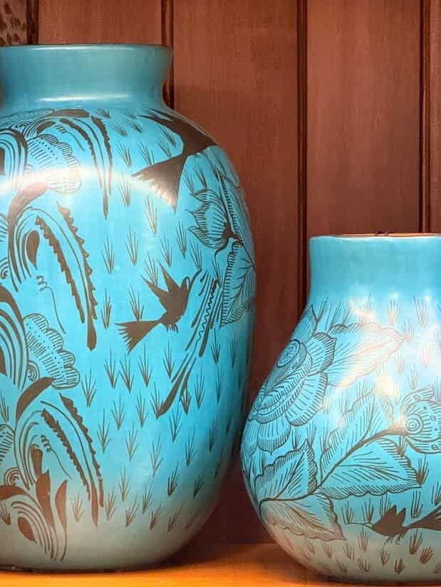 A pair of turquoise Huáncito vessels drawn over with dark birds, grasses and flowering branches