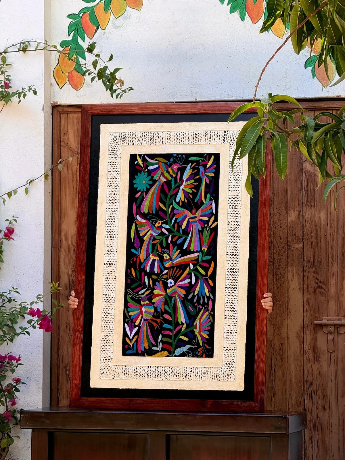 Amate Wall Art with Black Tenango Embroidery – Framed wall hanging featuring traditional amate art